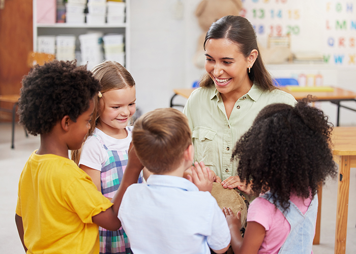 Shot of a woman teaching her class about musical instruments.